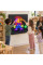Several students placing pegs on the Interactive Light Panel together